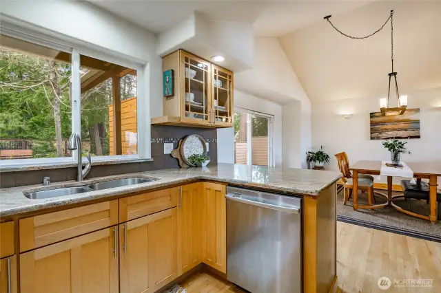 Dishes , no problem ! Nice big window above sink to look out to your beautiful back yard with mature trees and plants that'll bloom beautifully each Spring .