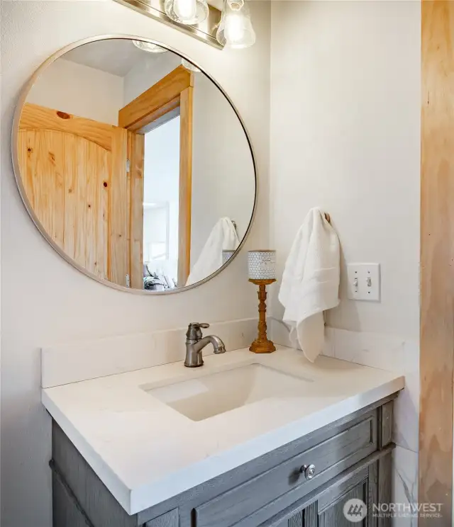 Main floor 1/2 bath with new vanity and fresh paint.