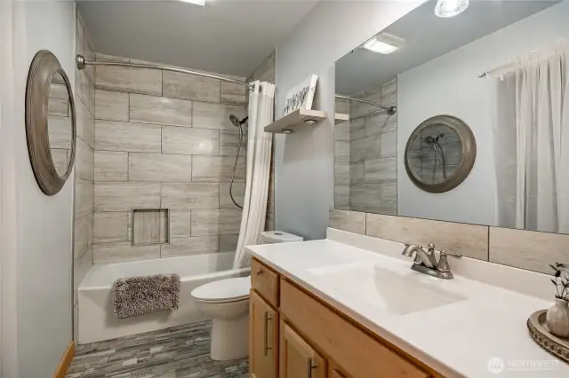 Downstairs full tiled bath .