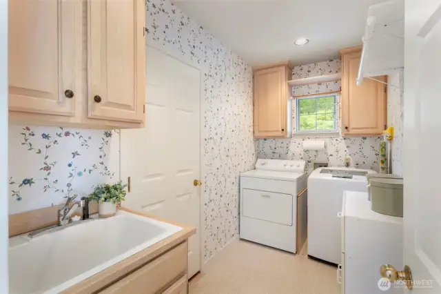Laundry/mud room to the 2-car garage with lots of storage cabinets - come see at your showing.