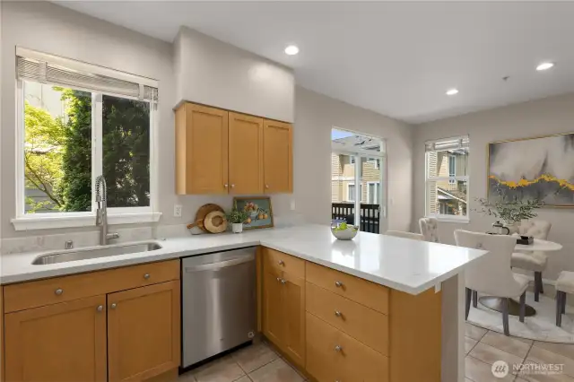 The open kitchen flows into the breakfast nook with direct access to the private deck—ideal for indoor-outdoor living and entertaining