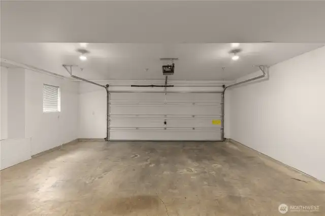 Spacious attached 2-car garage with additional storage space