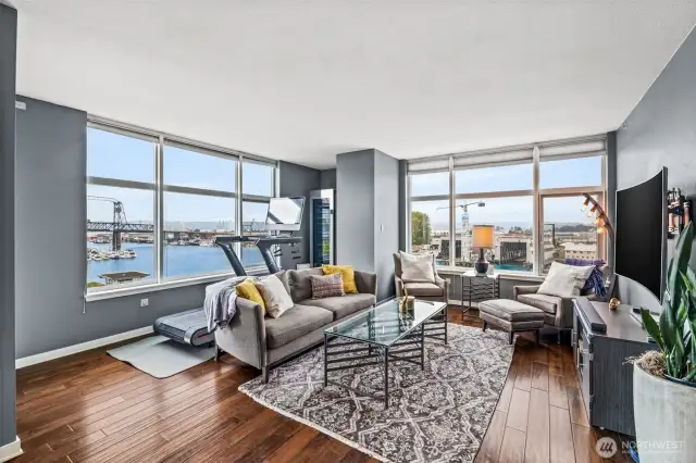 The 11th Street Bridge is shown outside the window on the left. The space behind the sofa is being used here as a fitness nook, with a wine cabinet in the corner. This is also an ideal space for a home office.
