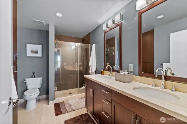The primary bath features a double vanity with marble counters and floors.
