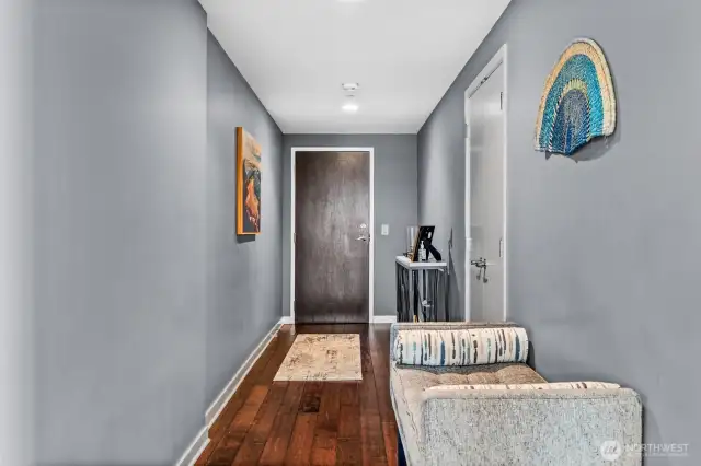 The art gallery entrance to this home awaits your favorite displays. The coat closet shown to the left is extra deep. You also have a storage unit in the garage area of the building.