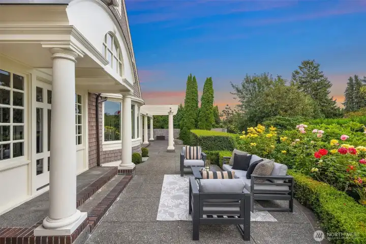 Pristine rose garden framing the lovely patio. Multiple doors from the home lead you to this sanctuary.