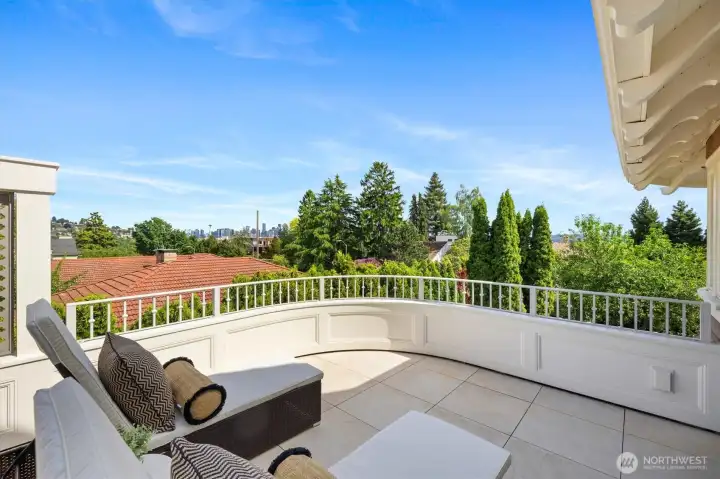 Private balcony off the primary bedroom with views of downtown Seattle