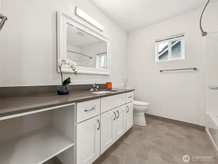 Full bathroom with quartz countertops