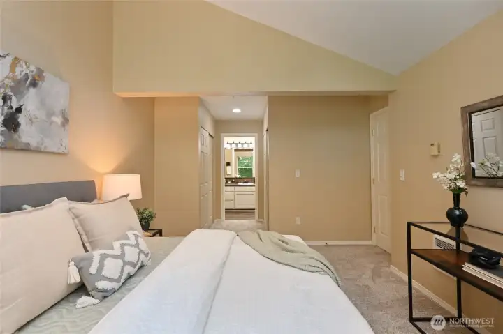 Your Ensuite awaits at the end of a hallway with spacious closets on either side.