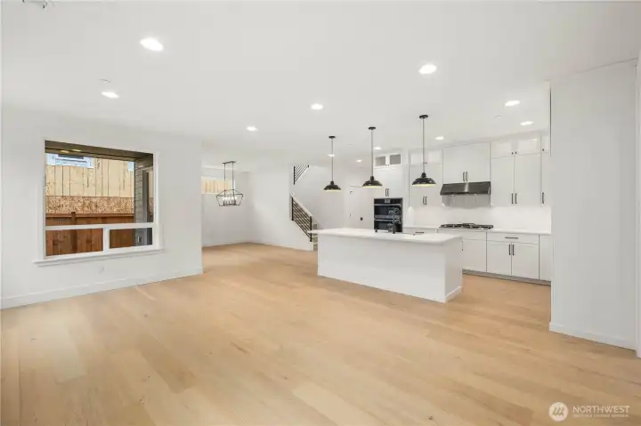 The great room’s expansive footprint connects seamlessly with the kitchen and dining area, enhanced by natural light from oversized windows. With room for multiple seating zones, this open concept is designed for easy entertaining and everyday comfort.    These photos are from Lot 3 at Gooden Hollow, which is the same floorplan. However, Lot 6 will have changes, so all photos, renderings, site maps, and floorplans are for visualization purposes only. Plans, colors, building orientation, finishes, home outlook, and other details can and WILL vary.