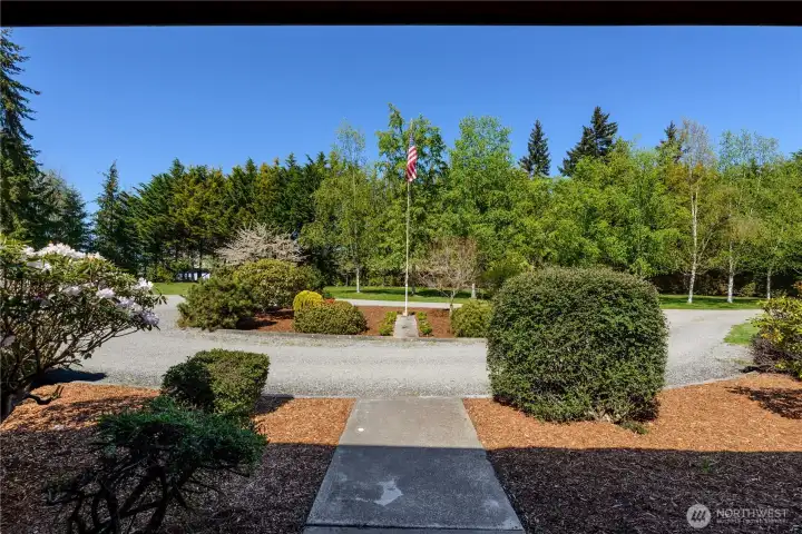 Beautifully landscaped entry to home from circular driveway