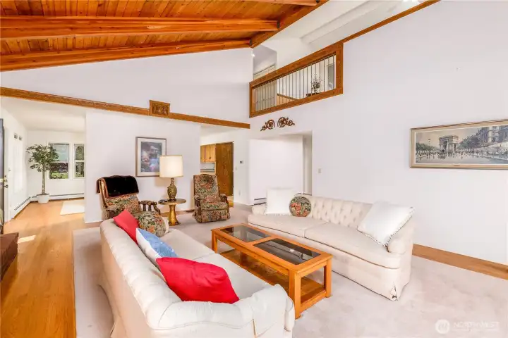 Another view of the open-concept living room, with two large entryways leading to the chef's kitchen