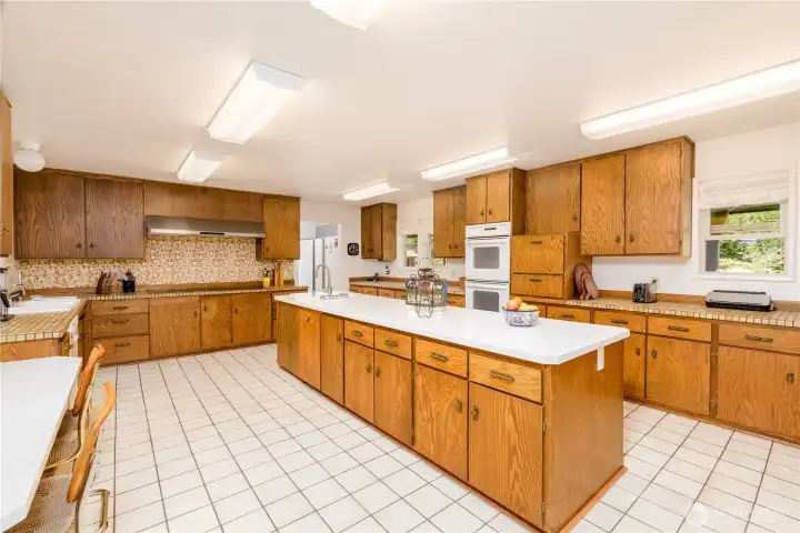 Large chef's kitchen featuring double-ovens and double-cooktops, plus tons of cabinetry