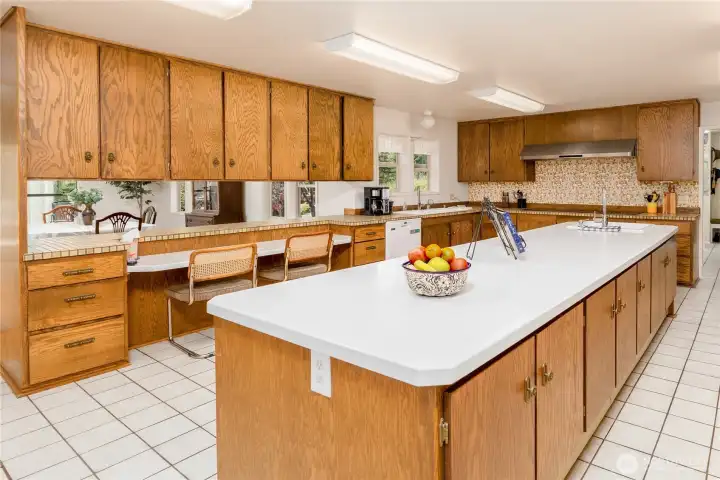 Amongst the abundant cabinetry and counterspace, a large desk is also featured in the kitchen