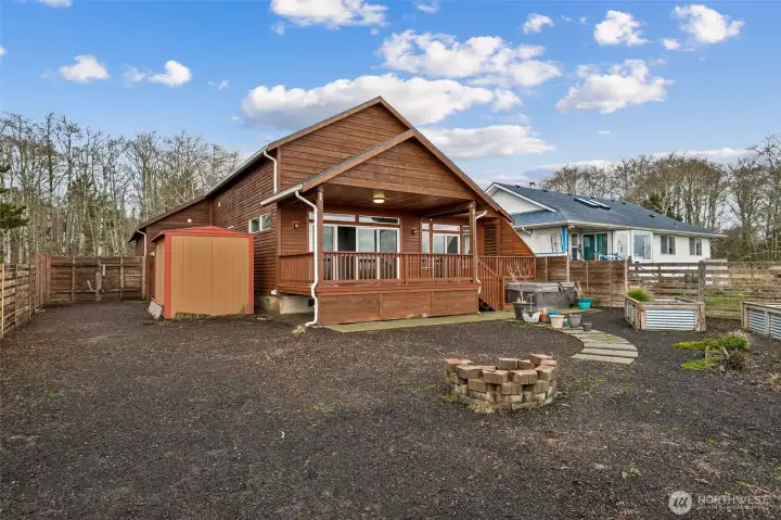 Backyard comes complete with fire pit and shed for extra storage