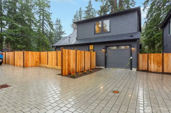 Garage with a dedicated parking pad to the right of it.