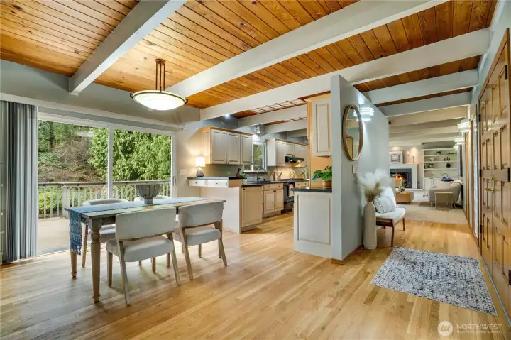 Dine in serenity—this dining room is steps from the kitchen and opens through large sliders to a deck immersed in natural beauty.