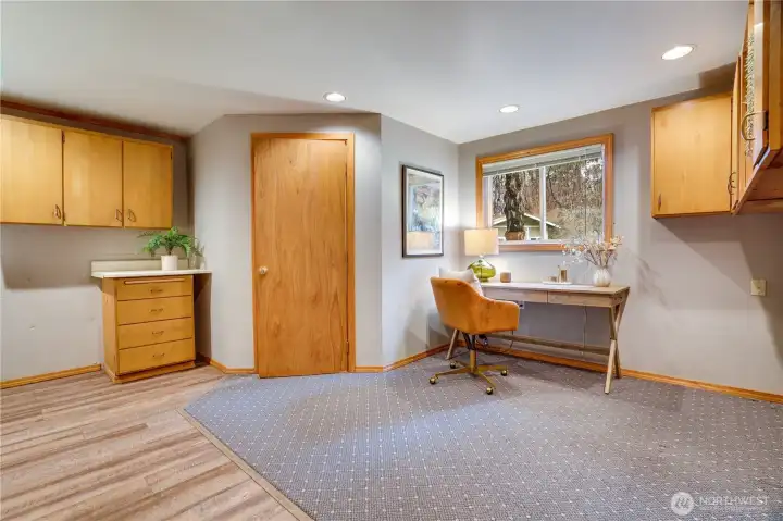 This utility/laundry/flex room has build in areas to set up an office or dedicated quiet space.  The 3/4 bathroom is behind this door