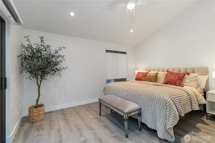 Primary bedroom with vaulted ceilings