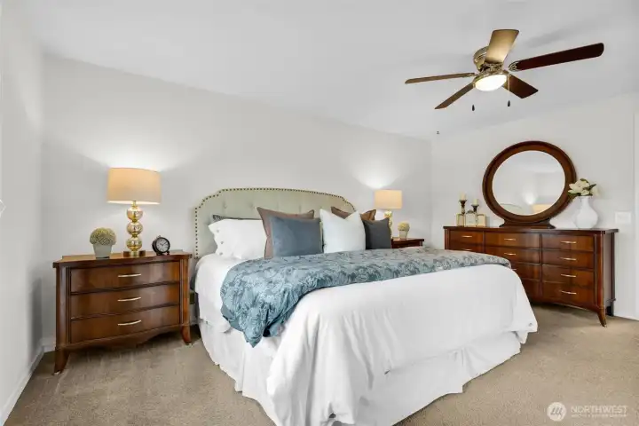 Large primary suite and paddle fan. Home also includes Heat Pump/AC cooling system. Photographed with King size bed.