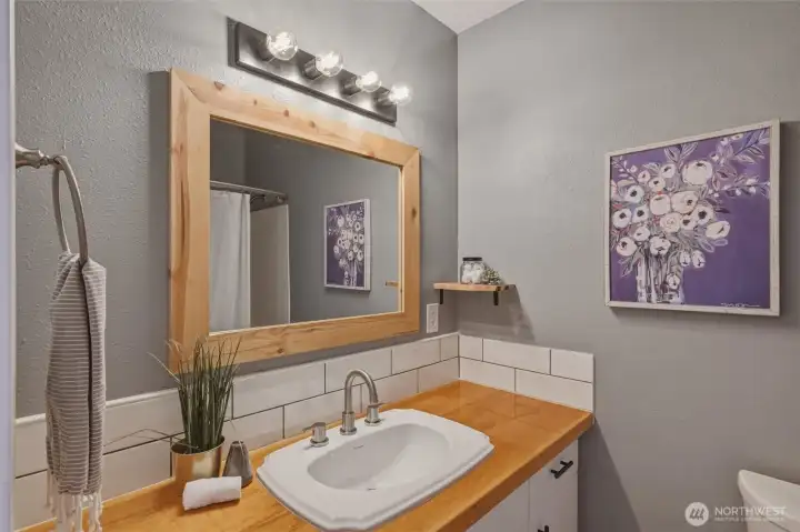 Full Guest bathroom with tub surround.