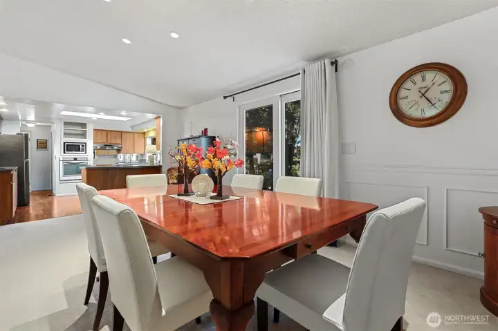 Formal dining room with vaulted ceilings has sliding door to patio that overlooks the greenbelt, trail and creek.   Opens to the dining room.