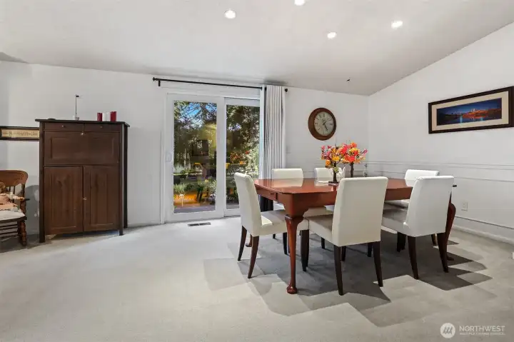 Formal dining room with vaulted ceilings has sliding door to patio that overlooks the greenbelt, trail and creek.   Opens to the dining room.