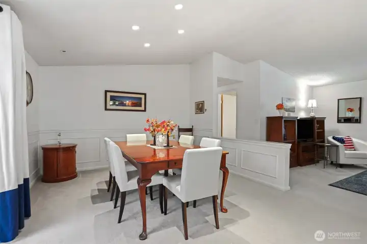 Formal dining room with vaulted ceilings has sliding door to patio that overlooks the greenbelt, trail and creek.   Opens to the dining room.