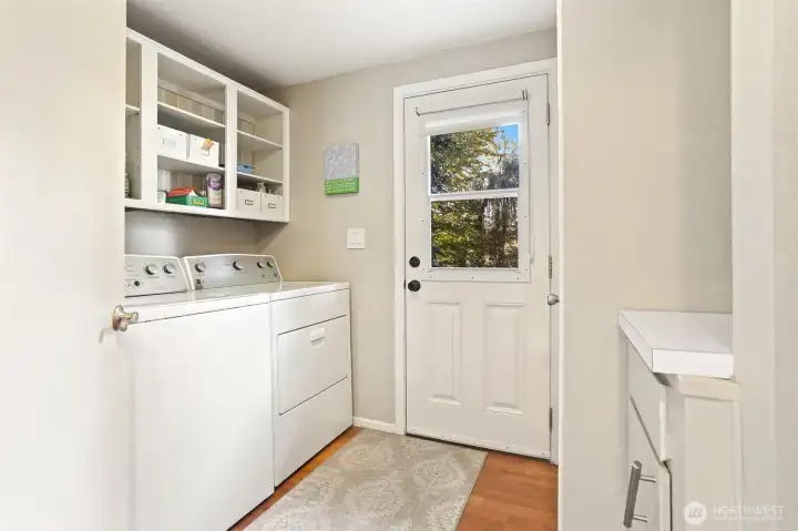 Utility room with a sink and full size washer and dryer.