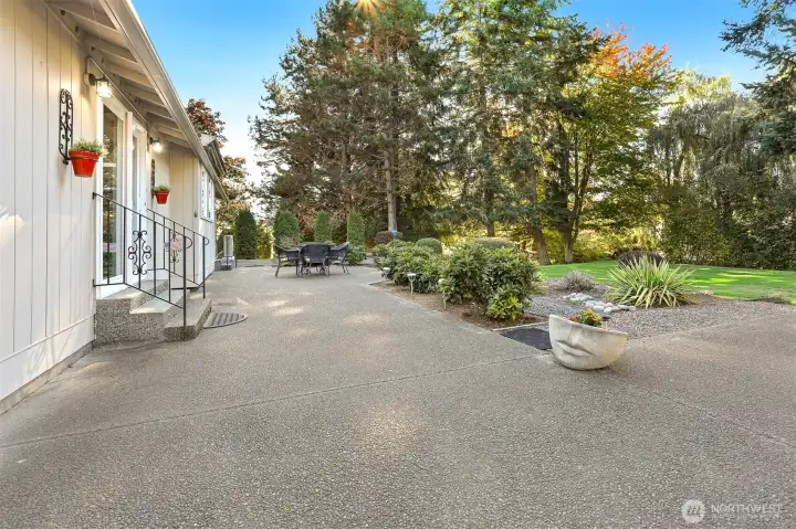 Front of home with a patio and bordering a community greenbelt, trail and creek on both the west and south sides
