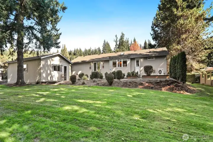 Front of home with a patio and bordering a community greenbelt, trail and creek on both the west and south sides
