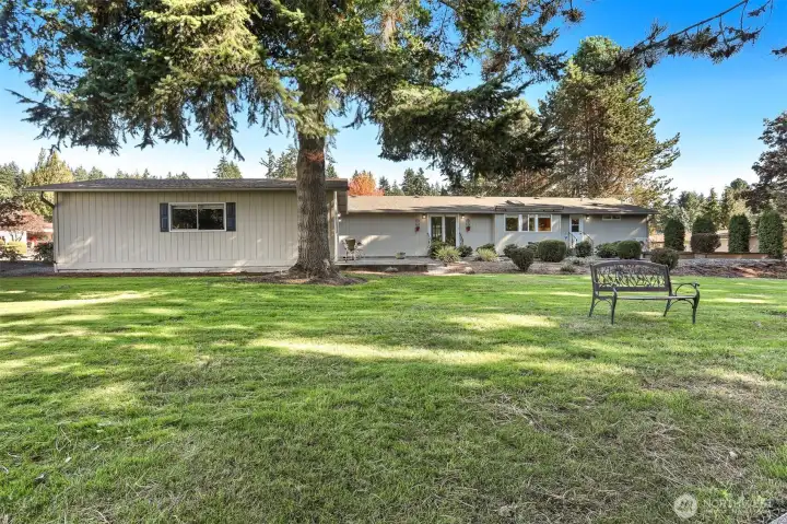 Front of home with a patio and bordering a community greenbelt, trail and creek on both the west and south sides
