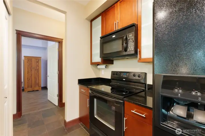 Kitchen has granite counters, cherry cabinets, slate flooring making the kitchen warm and inviting.