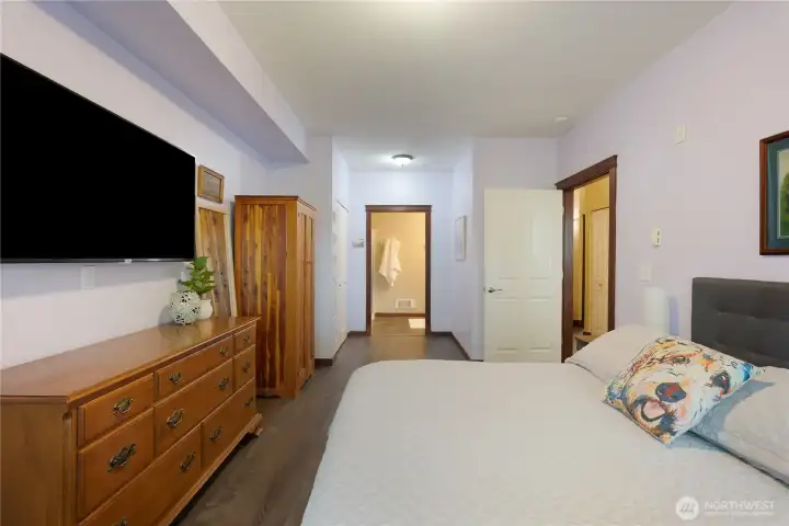 Primary suite leads to ensuite bathroom and walkin closet.