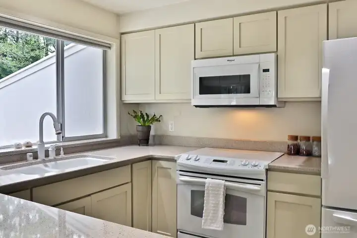 Updated kitchen with plenty of cabinet and counter space. There is a garbage disposal and pantry space.