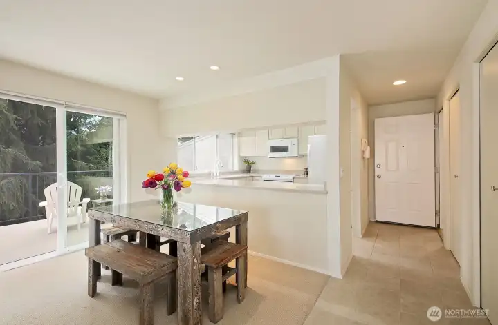 Your back is to the living room. Straight ahead is the open entrance door. There are 2 closets alongside the wall (right edge of photo). A glimpse of the spacious deck via sliding glass doors (left edge of this photo).
