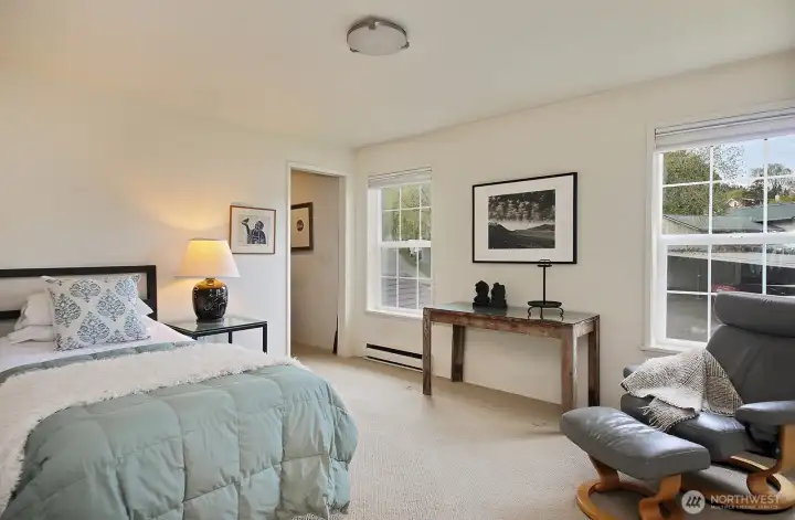 This is the larger of the two bedrooms. Straight ahead, through open doorway, is an office space that can also be converted back to a closet if desired. There are two other closets in this room (beyond the right edge of photo).