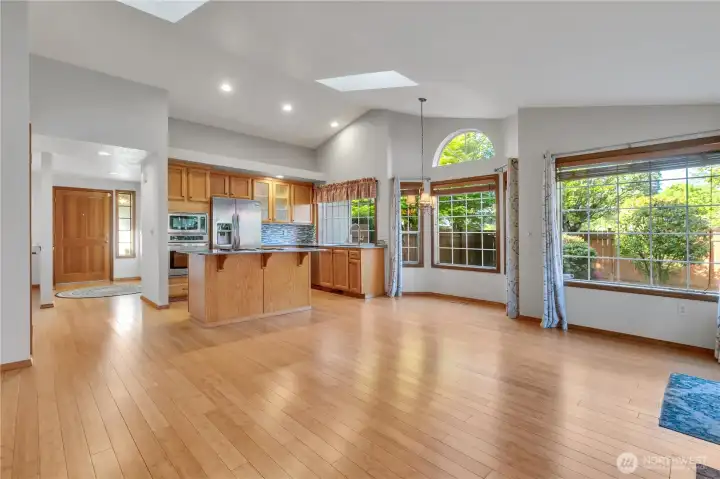 View from opposite end of this great room type family room looking to the large kitchen with island.