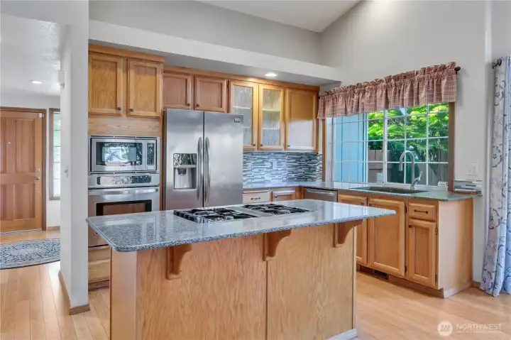 The kitchen was updated with granite countertops, all stainless appliances with gas cooktop for the gourmet chefs, graphite drop-in sink, tile backsplash and new glassed cabinet doors... so nice!