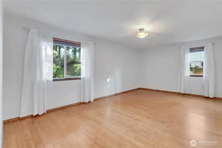 Enormously large primary bedroom, also boasting the lovely gleaming bamboo hardwood flooring!