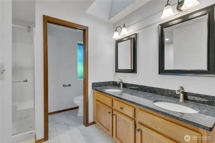 Wonderful remodeled primary 3/4 bath boasts new granite counters, new drop in china sinks and new faucets. The spacious shower is also all redone!