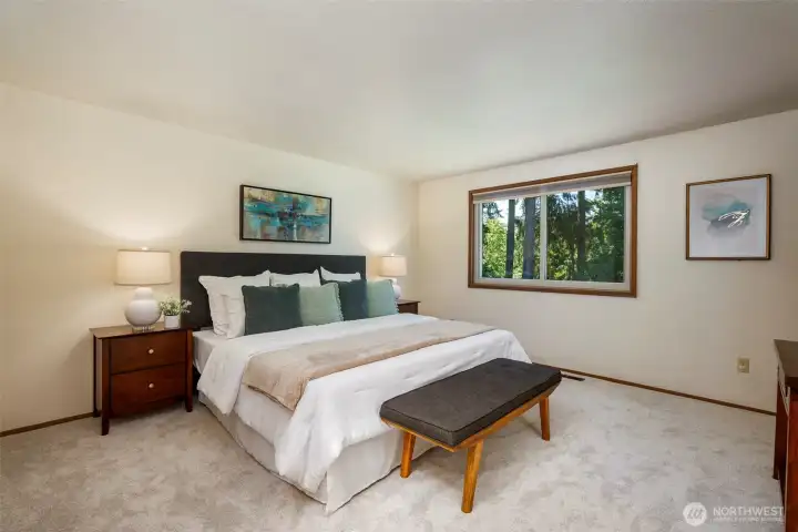 Spacious primary suite enjoys private outlook
