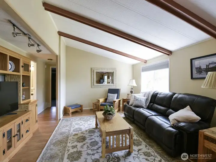 Relax in the cozy living room that feels spacious with vaulted ceilings.