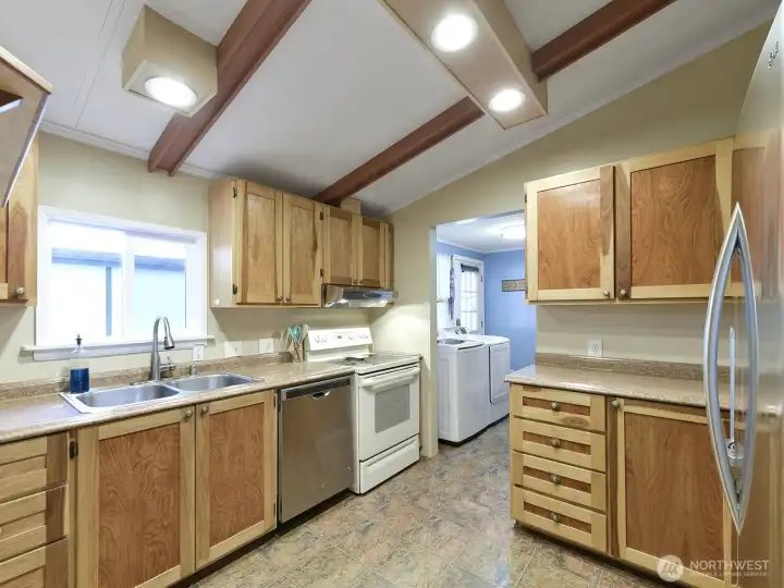 The kitchen has the vaulted open ceilings with all appliances staying.
