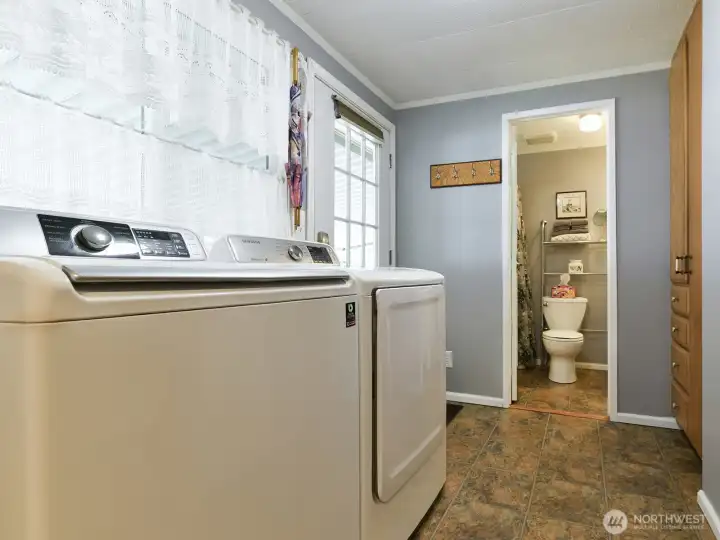 The laundry room has access to the back door and full bath, with lots of storage cabinets, and small counter / desk area.  Newer washer and dryer stay with the home.