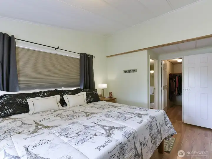 There is enough room for a king size bed, 2 night stands and dresser in this space.