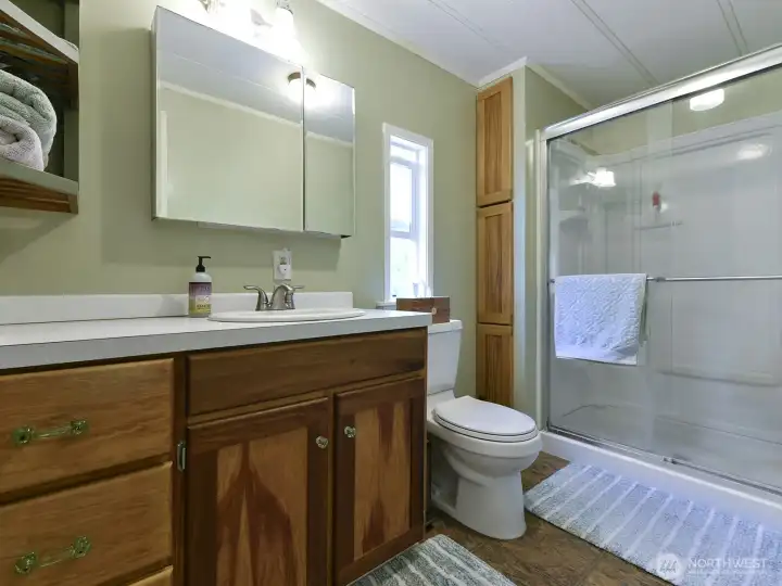 The primary 3/4 bath is just steps from the bedroom area.