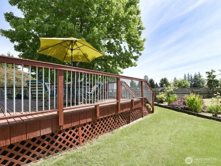 This fenced yard is bigger than you'd think, lovely blooming roses, rhododendrons, shrubs and trees and raised gardens for flowers or vegetables with territorial views and beautiful sunsets.