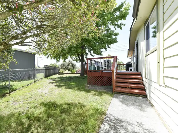 The large deck provides space for outdoor living, barbecuing and entertaining, perfect for enjoying the peaceful territorial view and beautiful trees for shade.