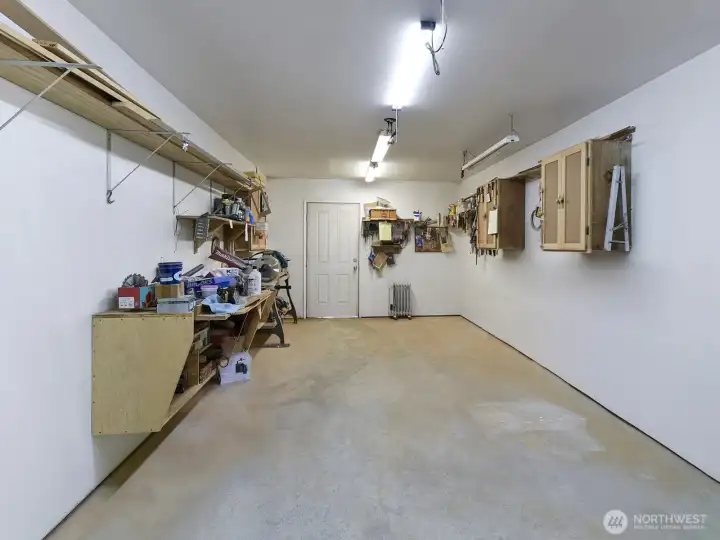 This large detached shop has lights and power and is great for hobbies, exercise equipment, storage or whatever your flex space desires or needs, (was used for wood working), with a back door access to the back yard area and garden shed.
